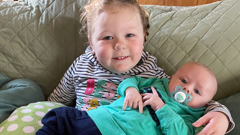 Baby Greer is held by his big sibling