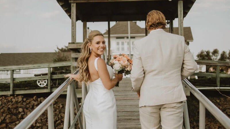 Stacey Pattberg holds hands with new husband as they walk up the stairs