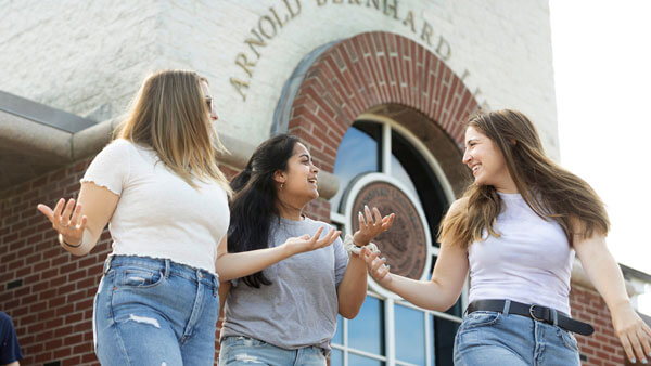 Girls walking out of Arnold Bernhard Library