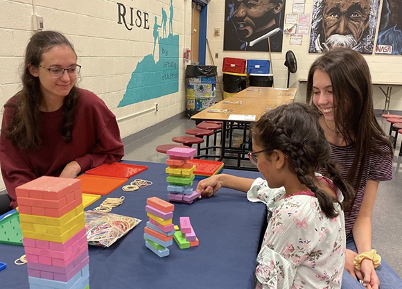 A student-teacher works with a student.