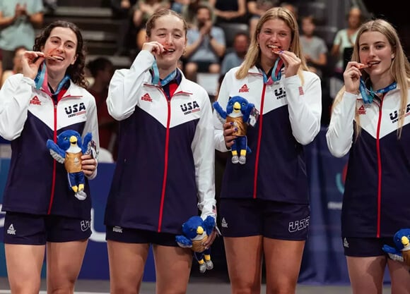 Jackie Grisdale holding a bronze medal with Team USA