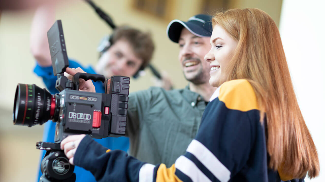 Student goes to record on a camera with a professor