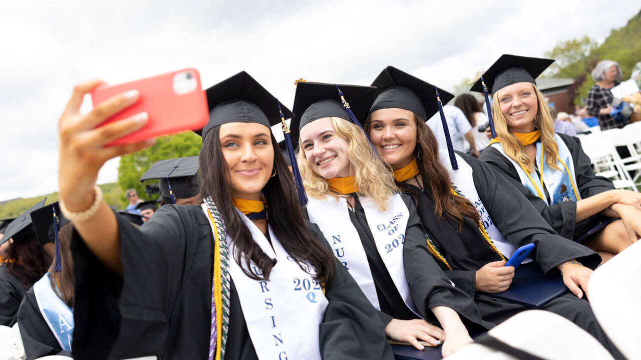 Friends taking a selfie in their caps and gowns
