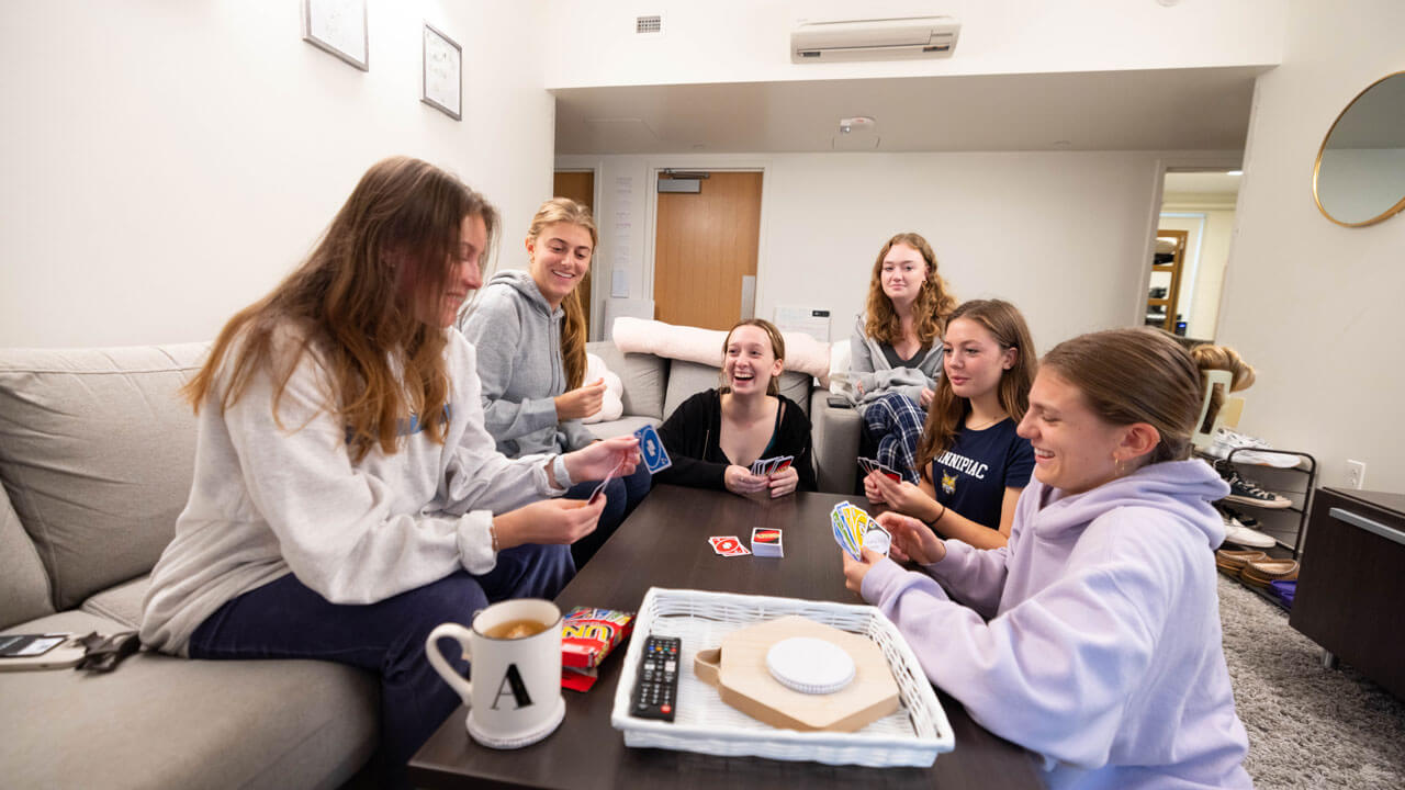Students in Larson dormitory play cards