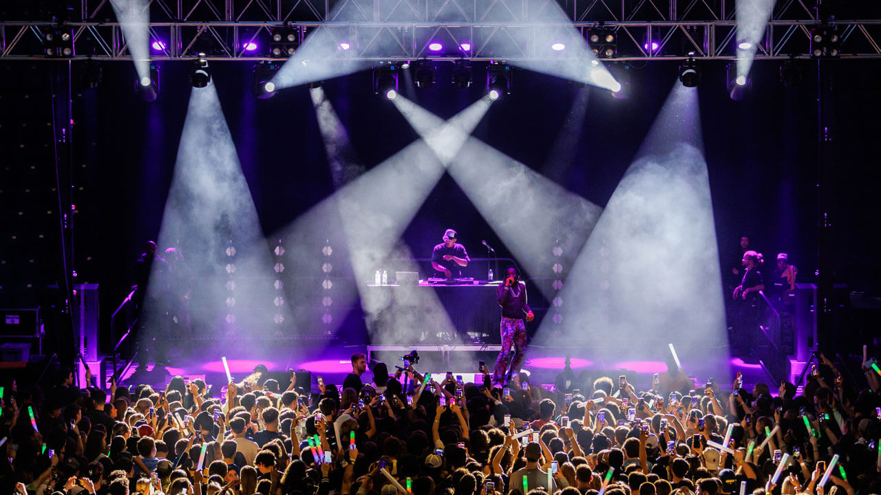 M&T Bank Arena lit up by purple and blue lights at Wake the Giant