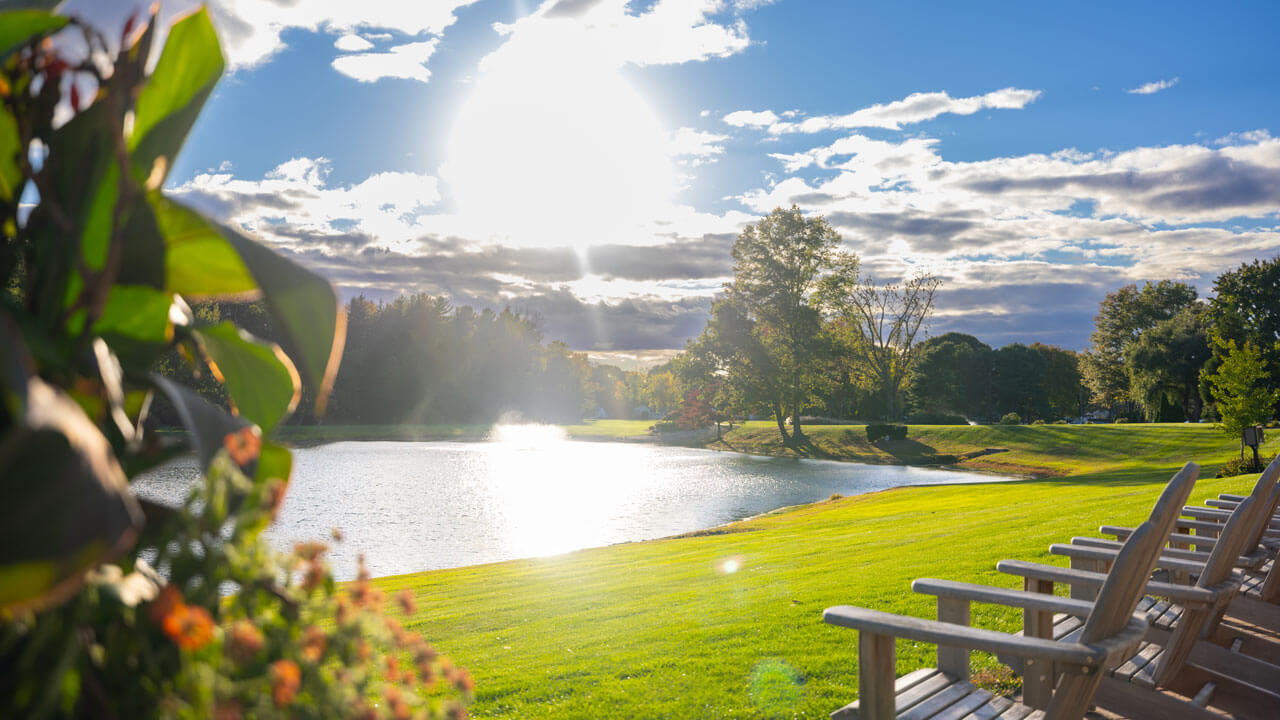 Beautiful sunny view of North Haven pond with benches facing the sun