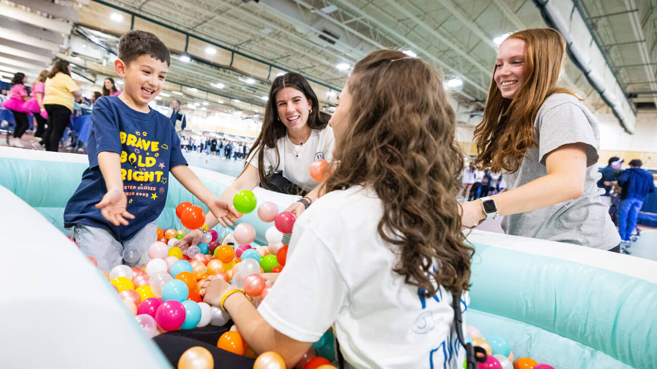 Participants at QTHON play in a ball pit