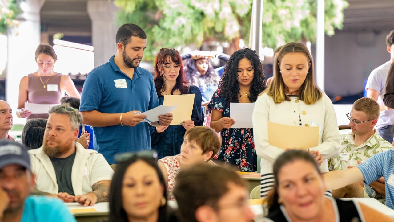 People reading off a piece of paper