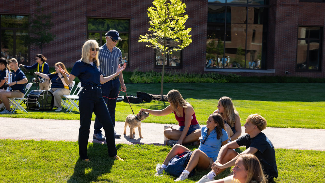 President Marie Hardin smiles and talks to students on South Quad