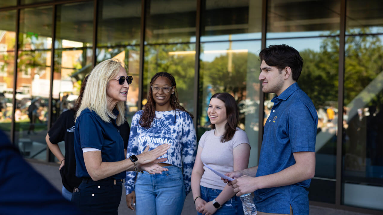 Students energetically talk to President Marie Hardin