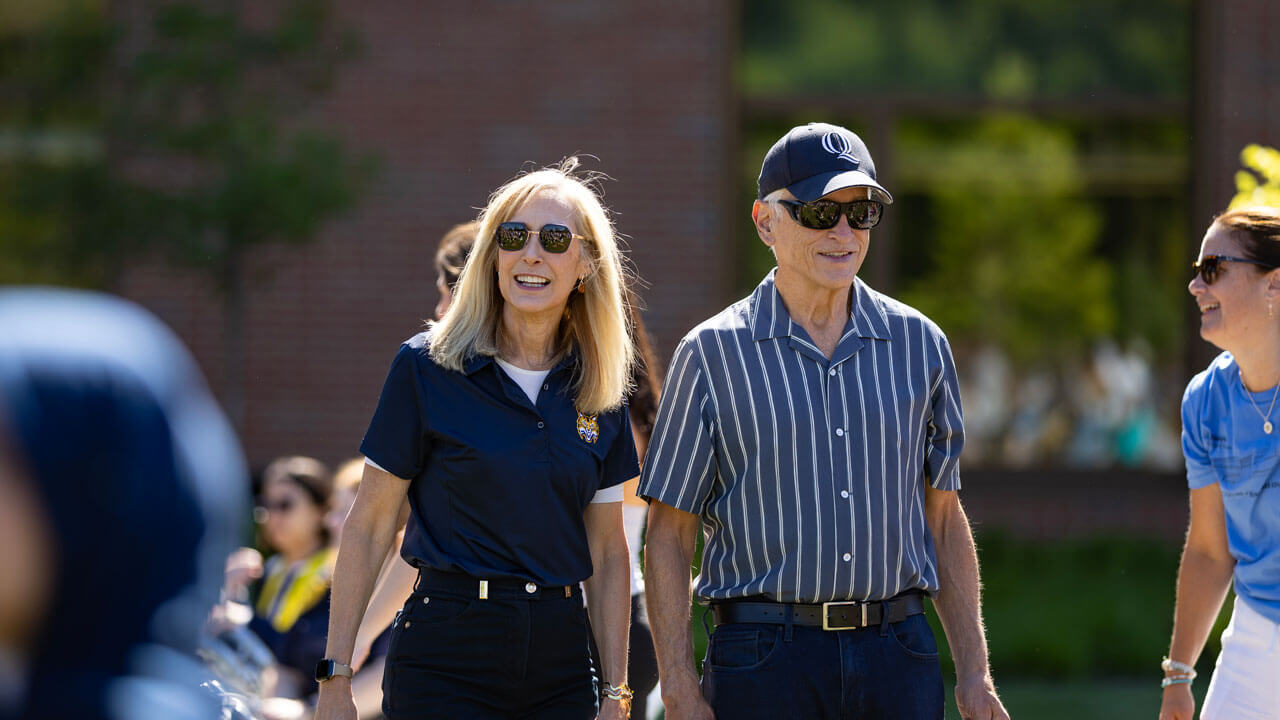 President Marie Hardin and her husband Jerry Kammer walk across south quad