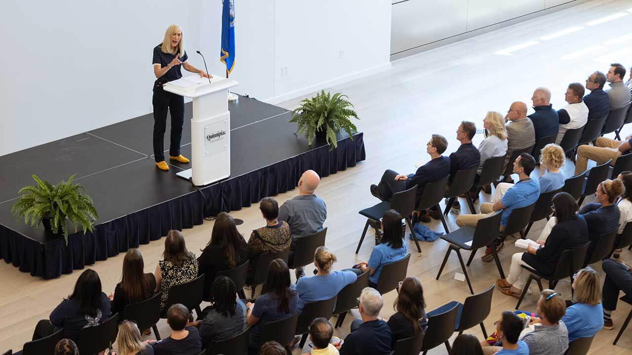 President Marie Hardin speaks at a podium.
