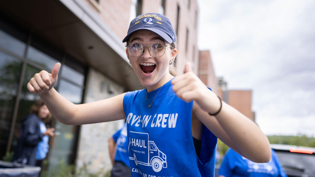 A move in crew student smiles for a photo.