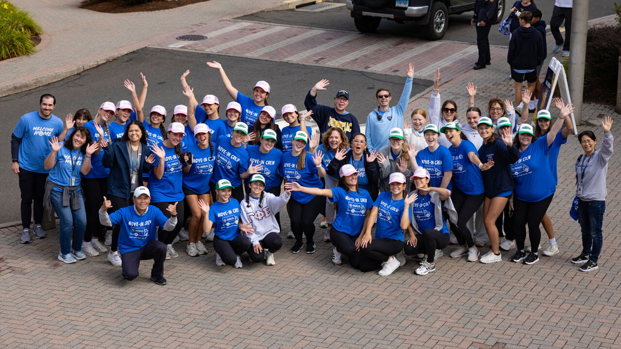 Move in crew participants smile in an aerial photo.
