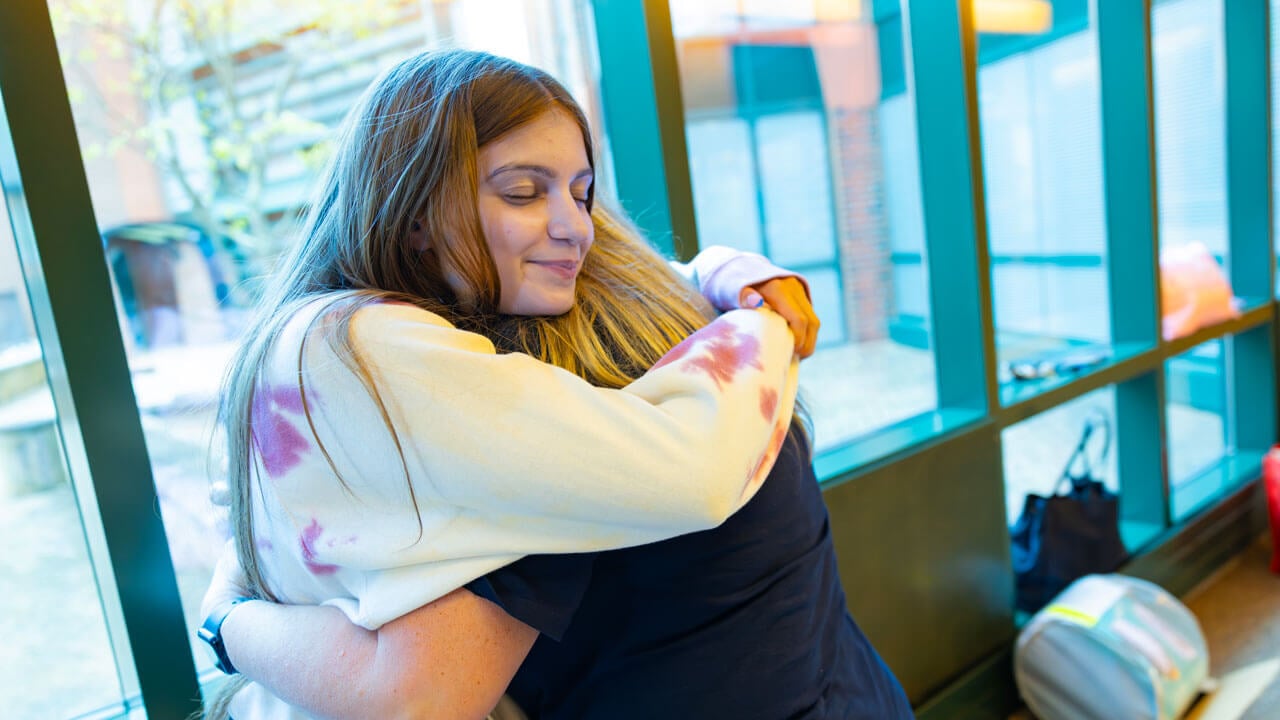 First year student hugs their loved one.