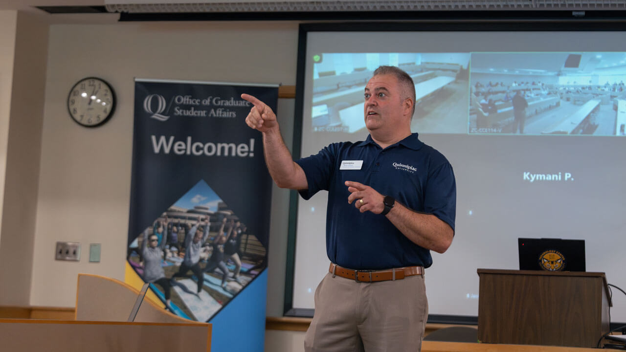 Faculty member speaks to graduate students.