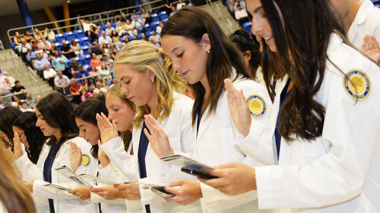 Students read their Oath during the white coat ceremony