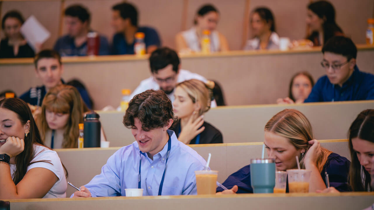 Students talking and taking notes