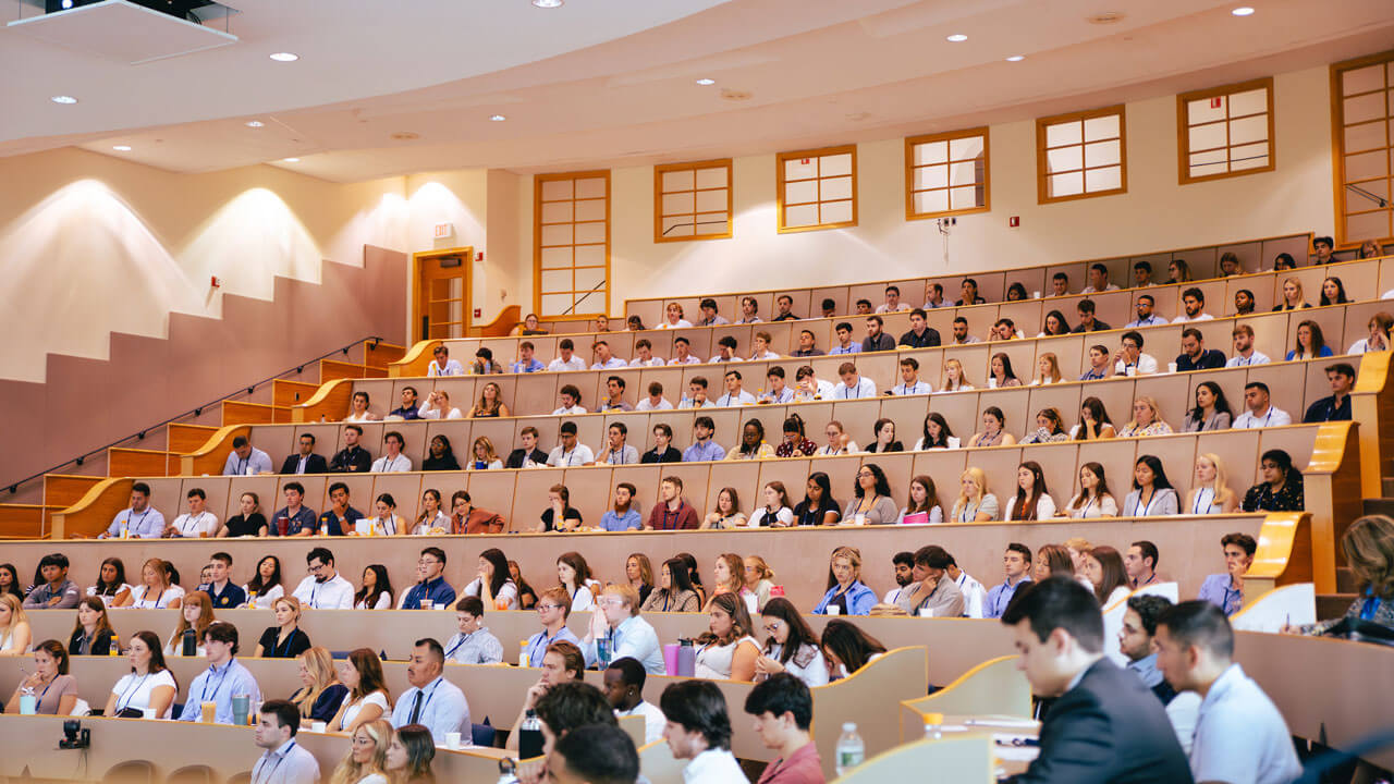 Students sitting down watching guest speakers