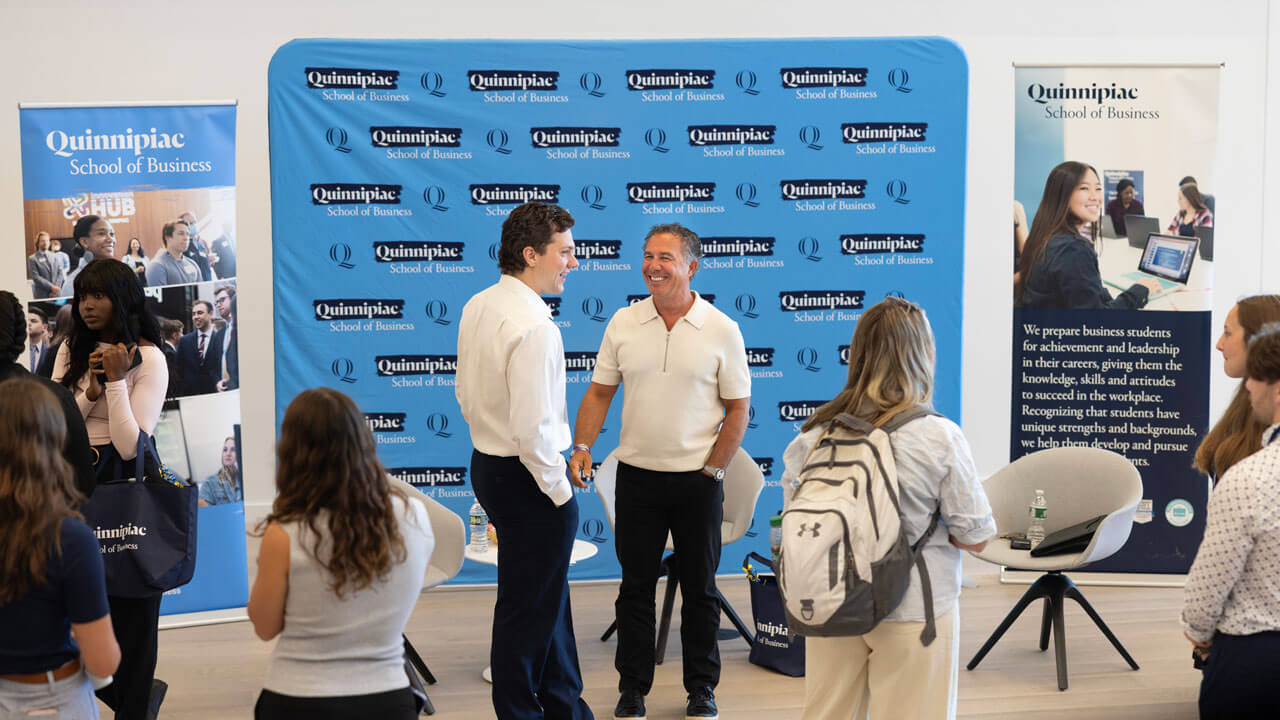 Chuck Saia laughs with a student