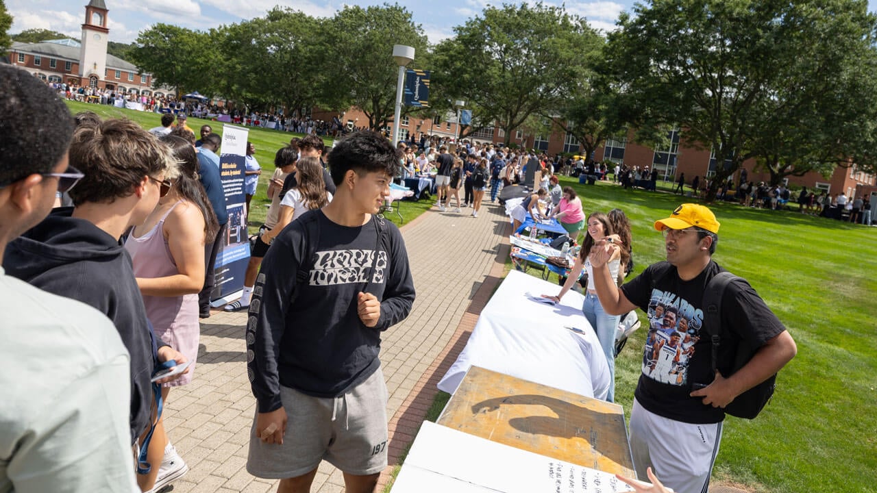 Students have an engaging conversation at a fair table