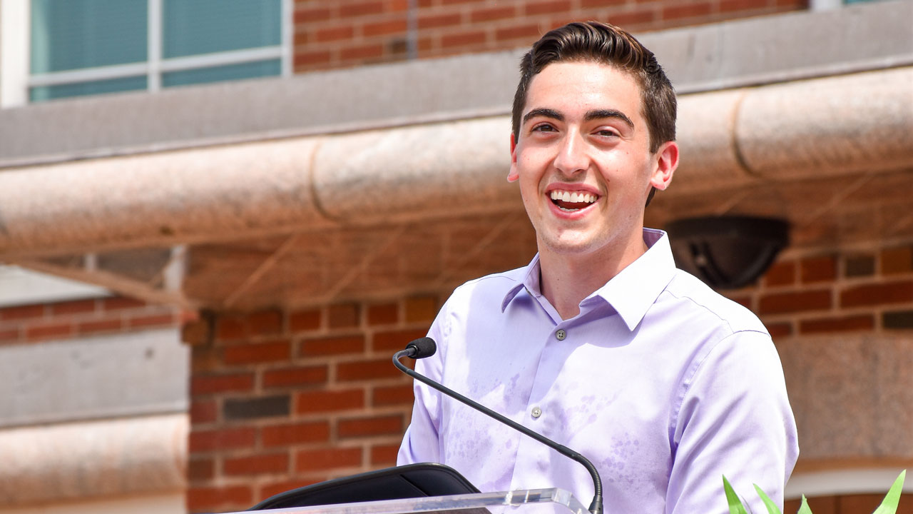 Nick Ciampanelli speaks from a podium during the welcome ceremony