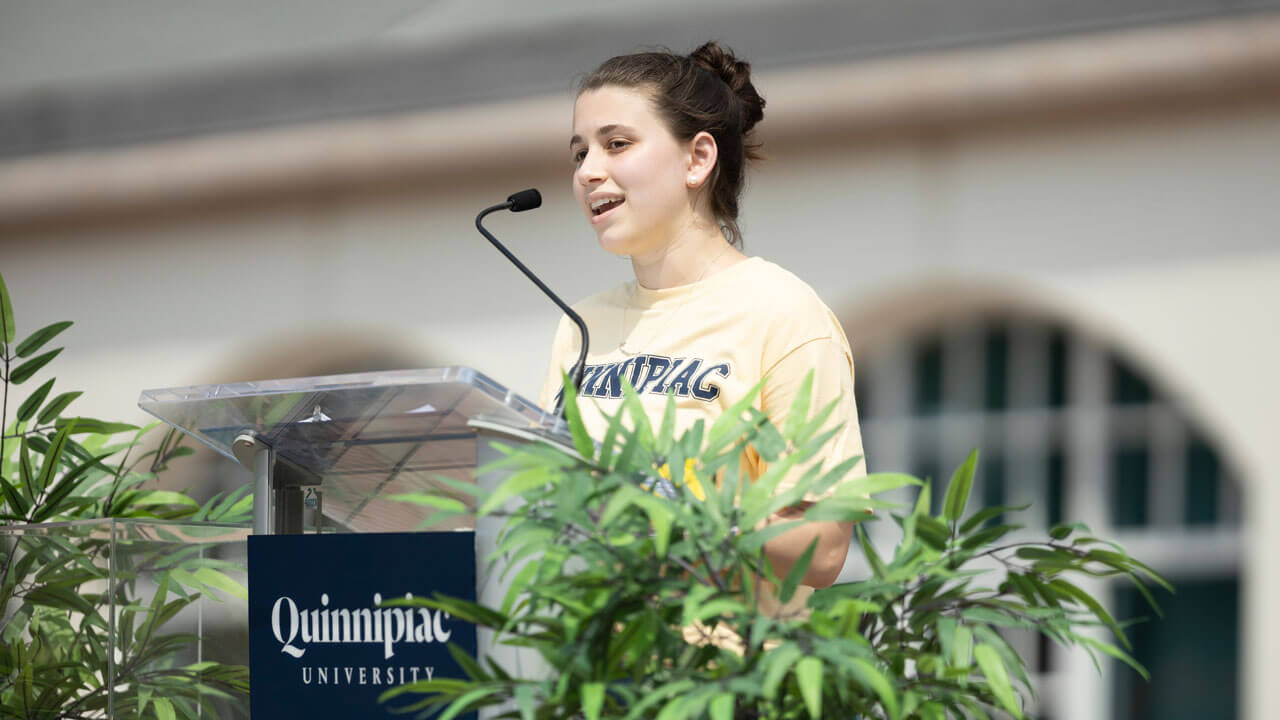 Ephemia Nicolakis stands in front of the library clock tower