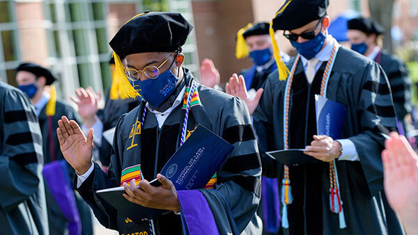 A law school graduate takes the professional oath at commencement