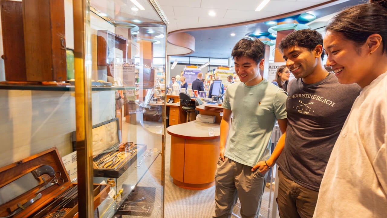 Students admire gallery case