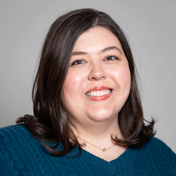 Dr. Rachael Lansang smiling against a grey background