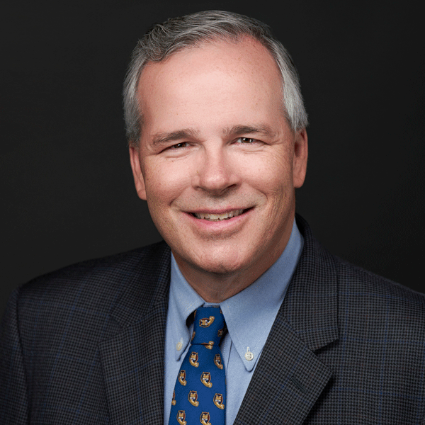 Tim Beach smiling against a black background