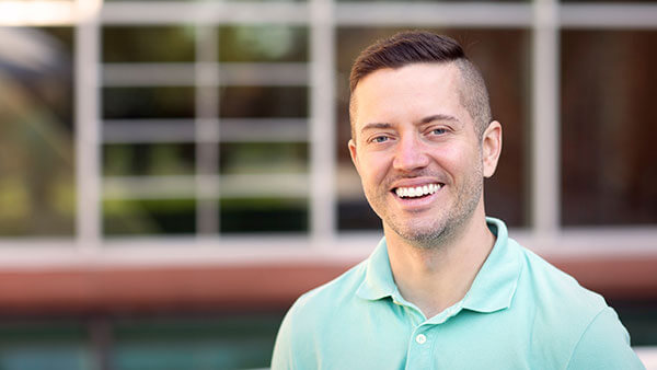 JT Torres stands outside on the Mount Carmel Camps.
