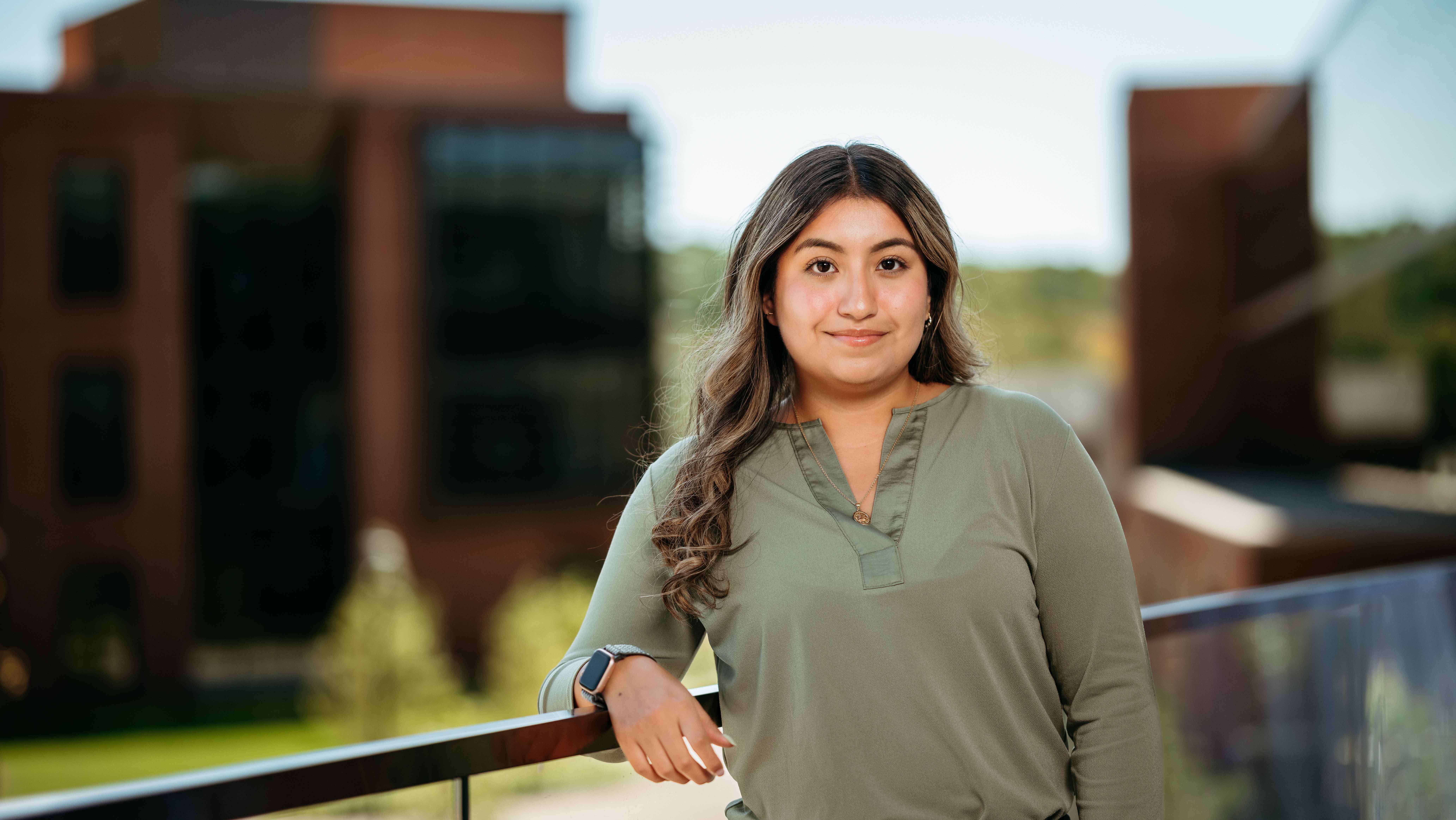 Ashley Naranjo, a Sawhney Leadership fellow, poses for a portrait on the balcony of the School of Business on the South Quad.