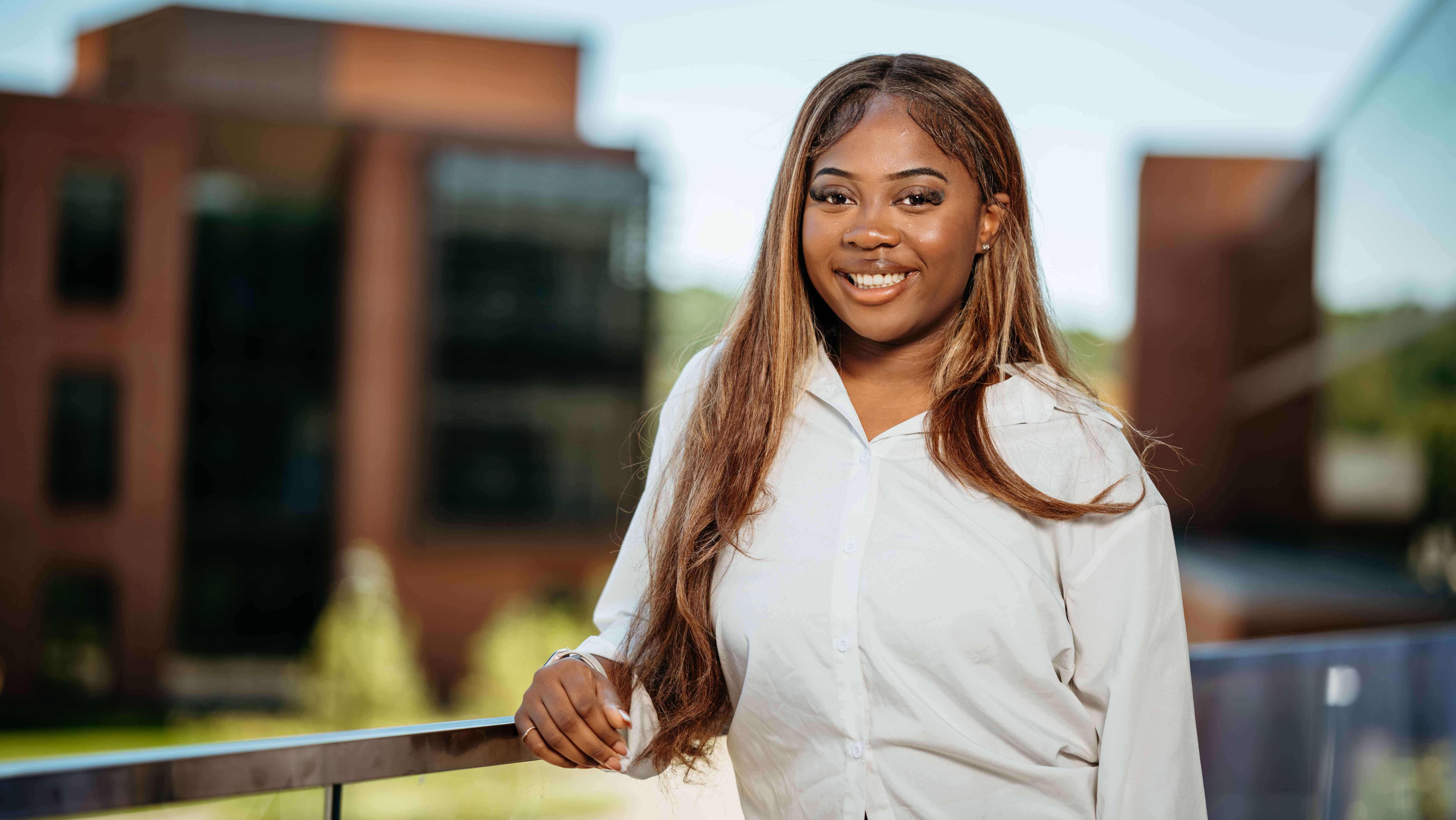 Timofe Oguntolu, a Sawhney Leadership fellow, poses for a portrait on the balcony of the School of Business on the South Quad.