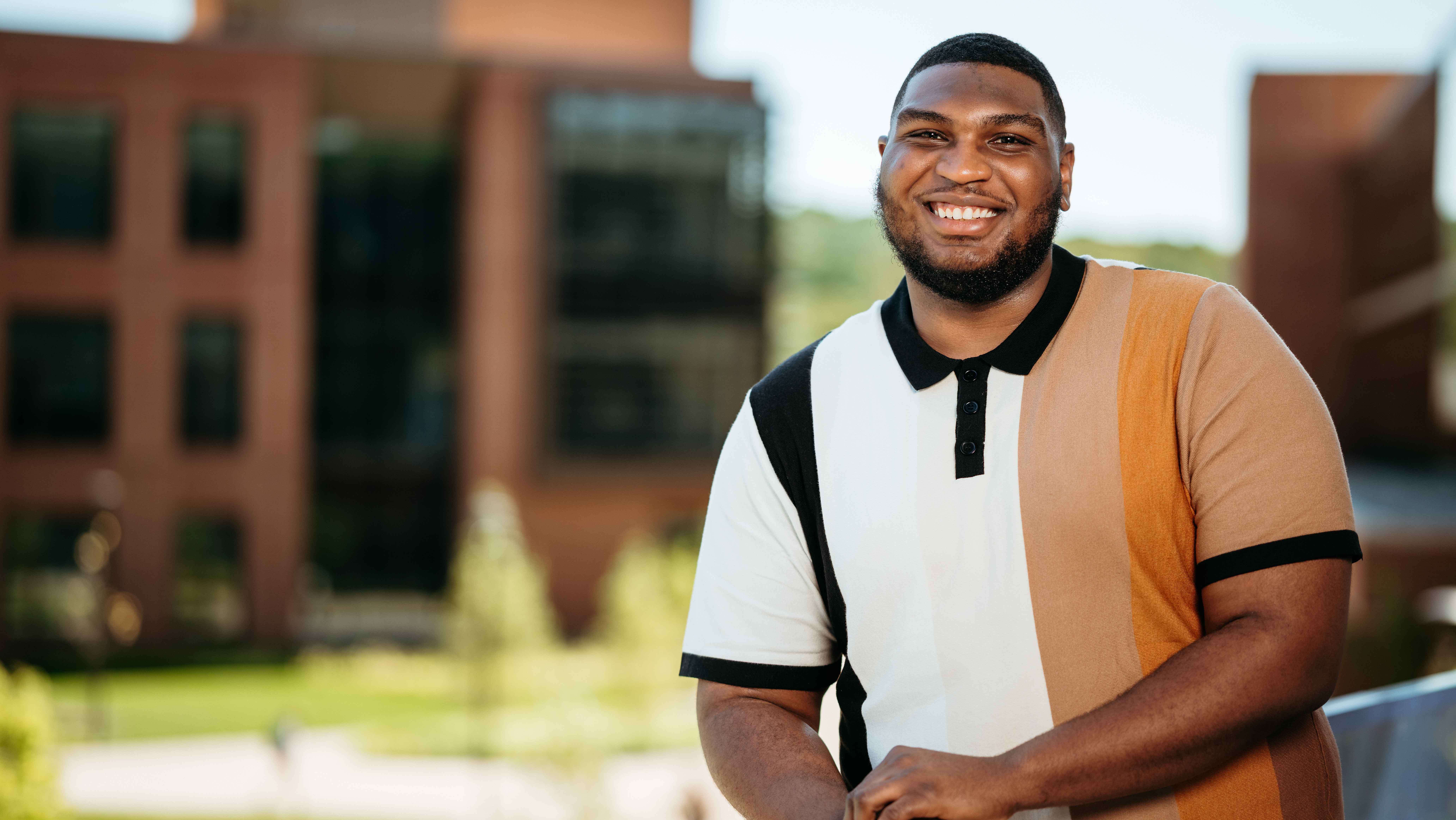 Darrell Jamison, a Sawhney Leadership fellow, poses for a portrait on the balcony of the School of Business on the South Quad.
