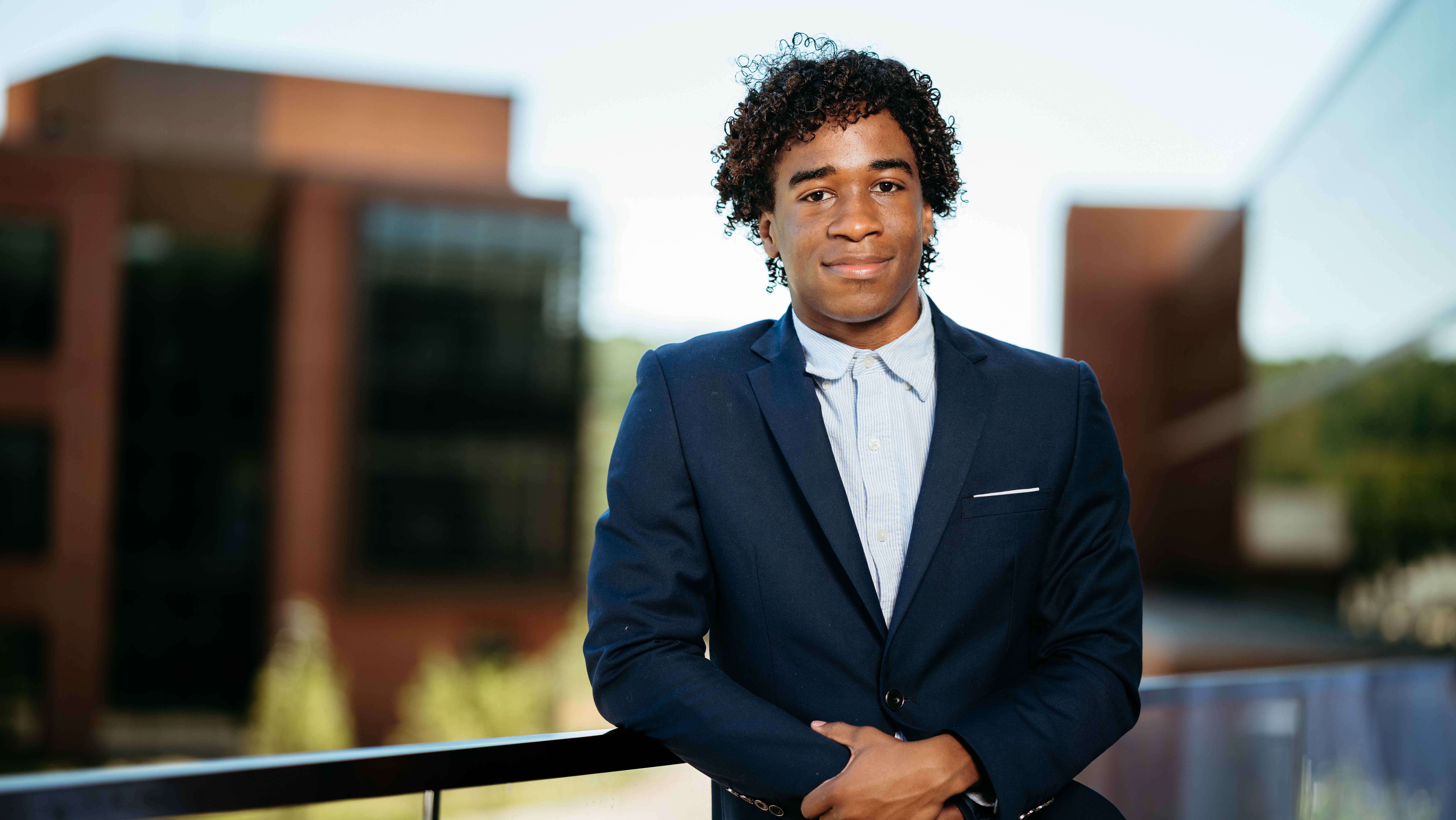 Isaiah M. A. Lopez, a Sawhney Leadership fellow, poses for a portrait on the balcony of the School of Business on the South Quad.