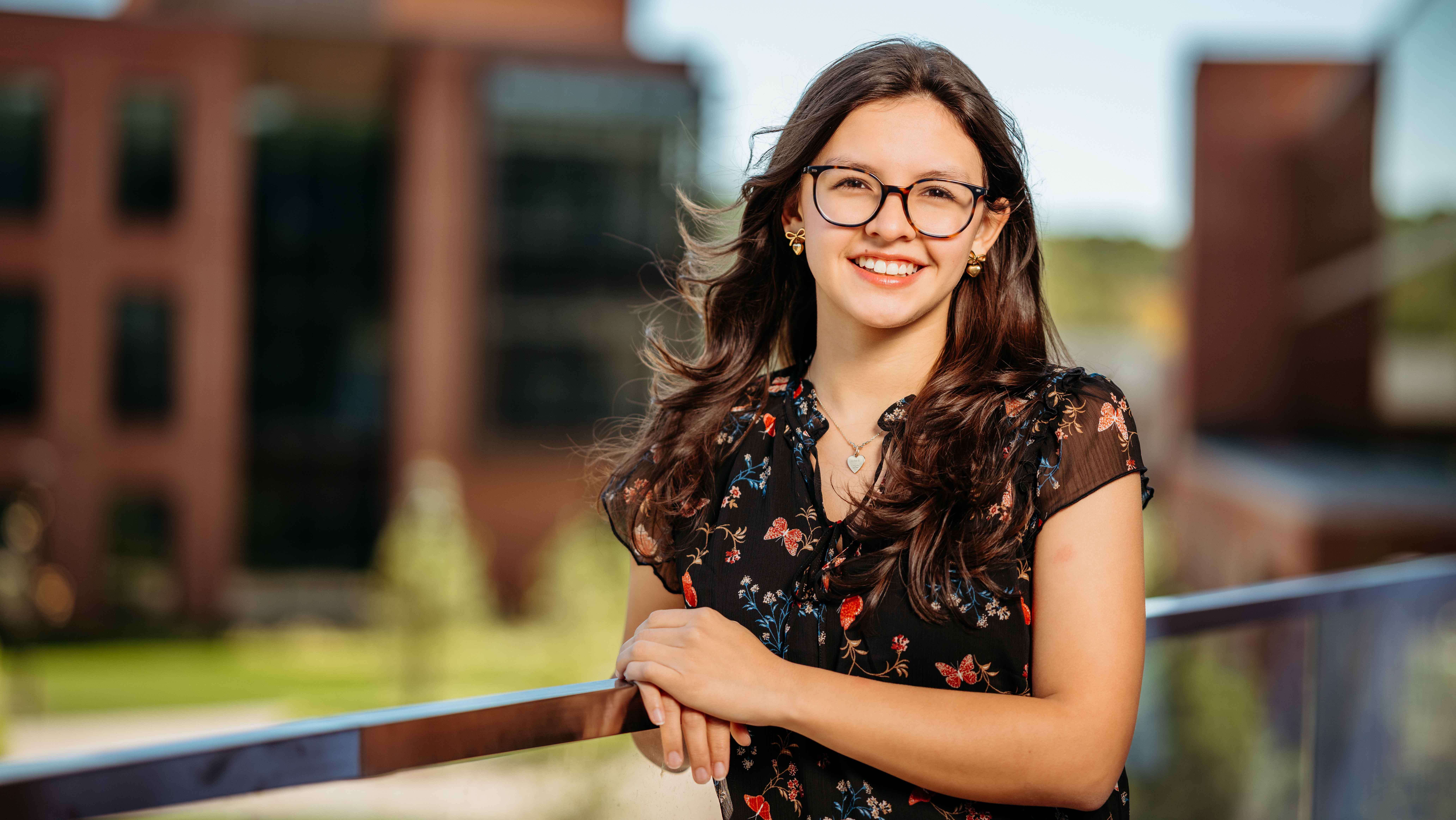 Sara Montes, a Sawhney Leadership fellow, poses for a portrait on the balcony of the School of Business on the South Quad.