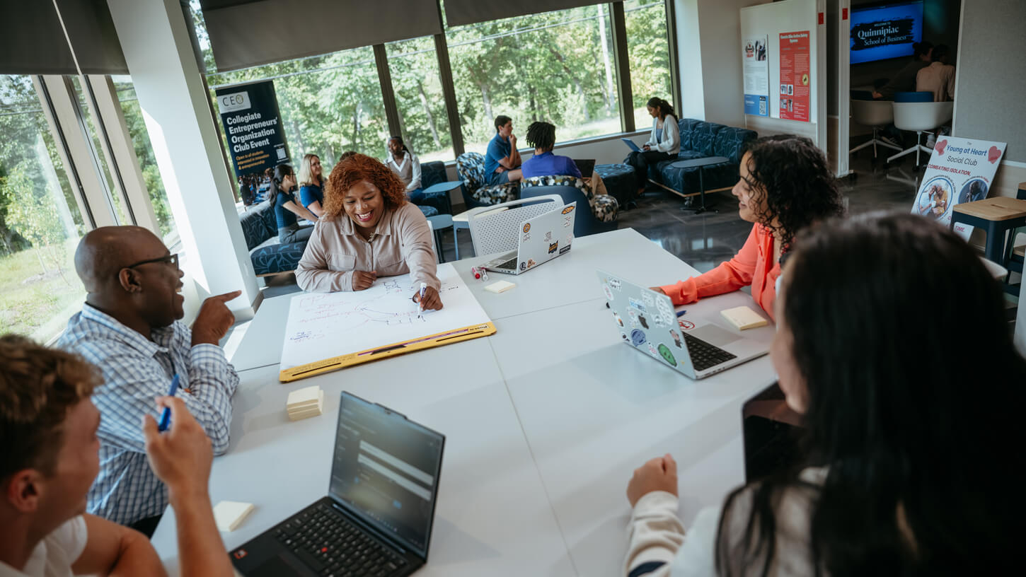 Business professor Robert Yawson collaborates with students in the Innovation Hub.
