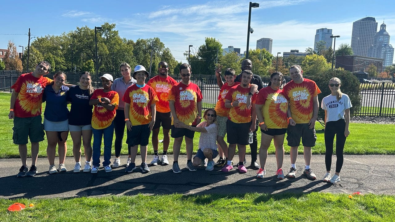 A group of athletes in matching shirts pose for a picture.