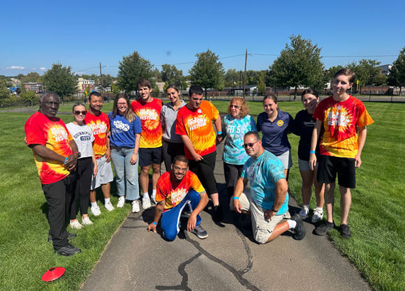 Special Olympics athletes in matching shirts pose for a group photo.