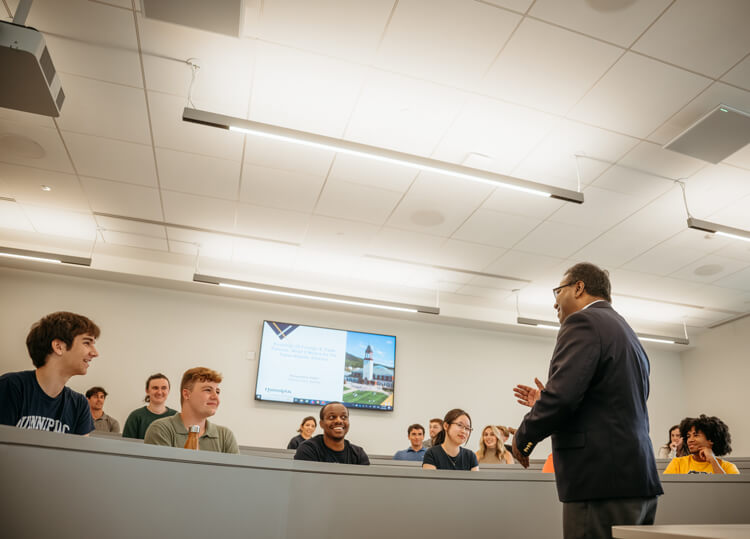 Students seated in a collaborative classroom while professor Mohammad Elahee conducts a lesson.