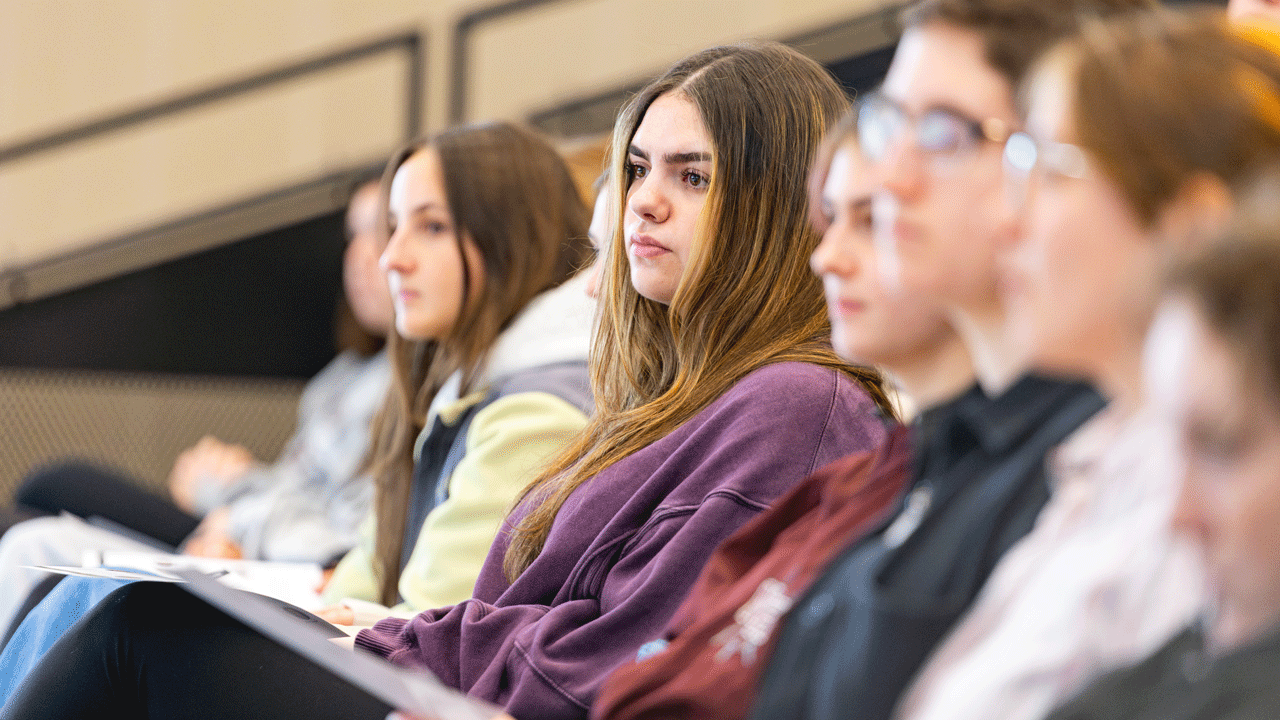 Crowd of people watching the panelist talk