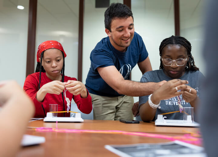 High school students work with a Quinnipiac professor and students during a health exploration camp.