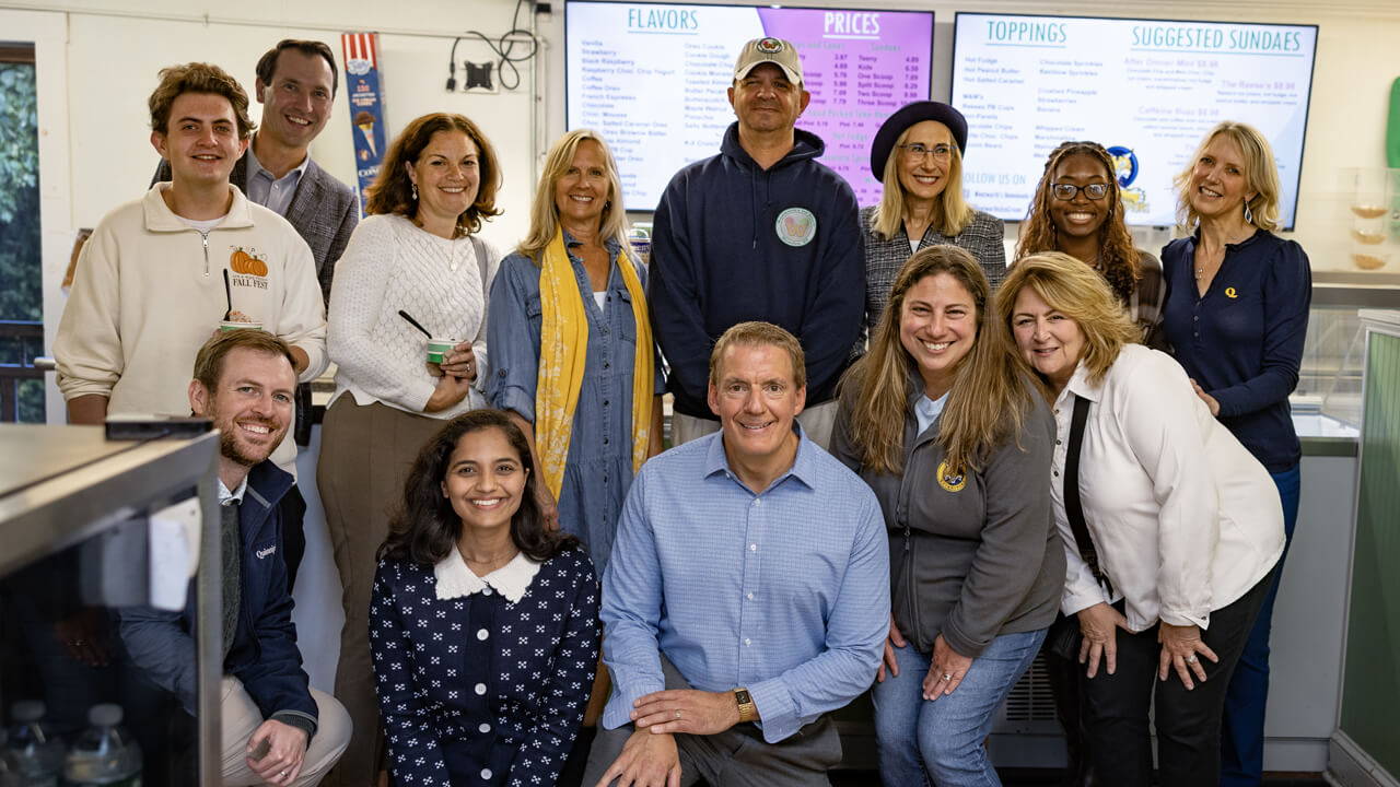 Quinnipiac community members smile for a group photo in Wentworth's ice cream shop