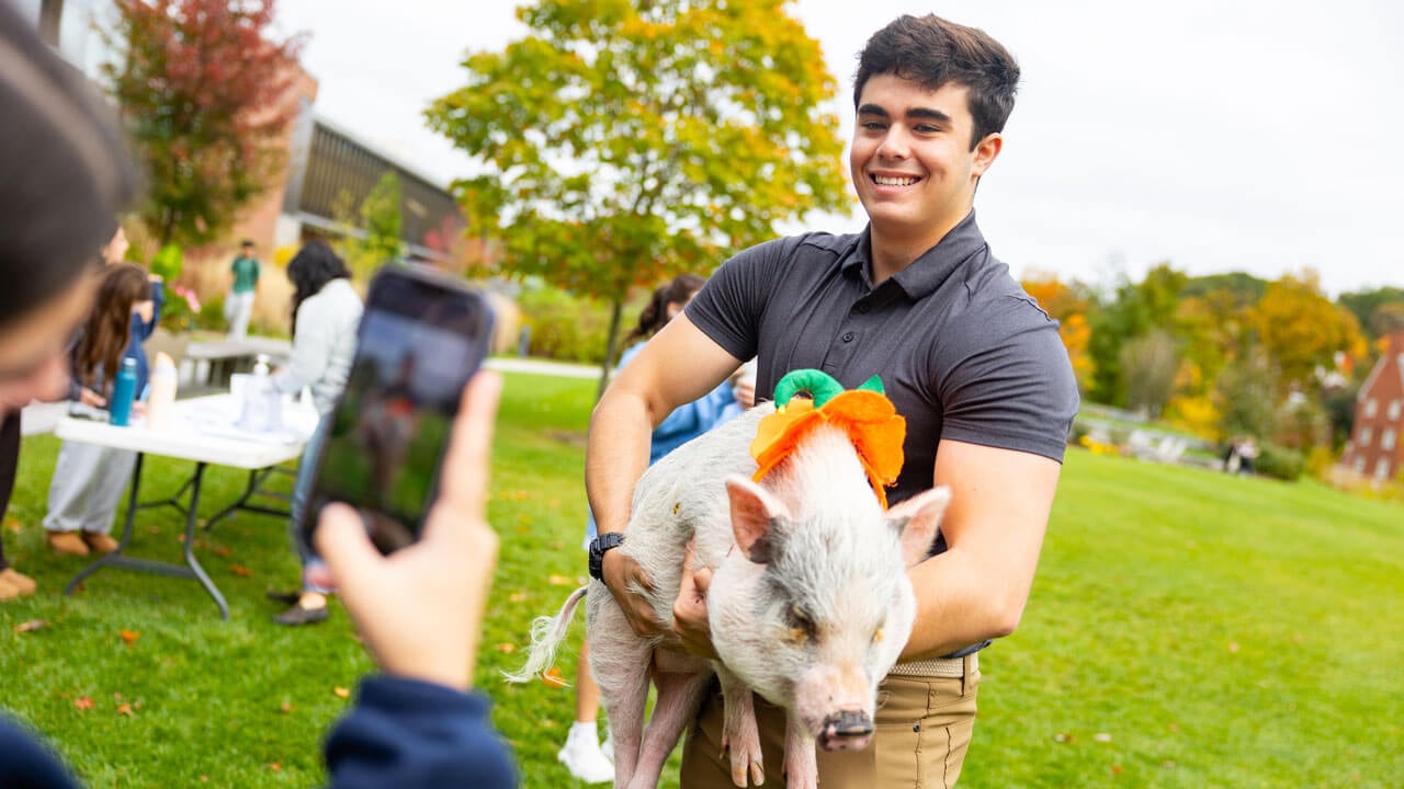 Students pose with a pig
