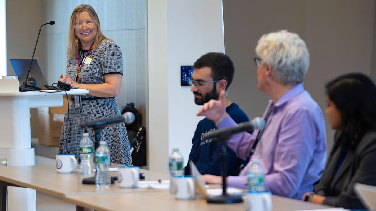 Students and faculty participate in a panel discussion.