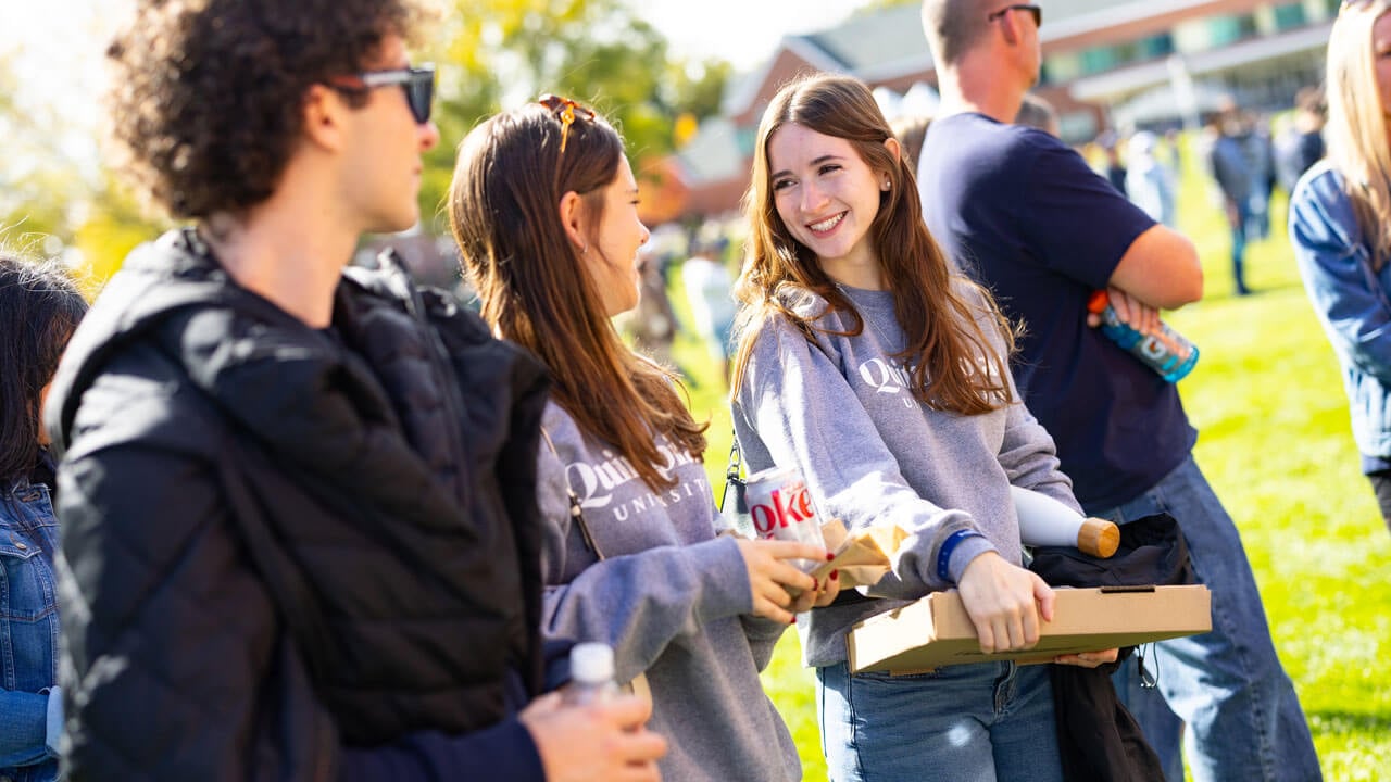Bobcats smiling and talking on the quad