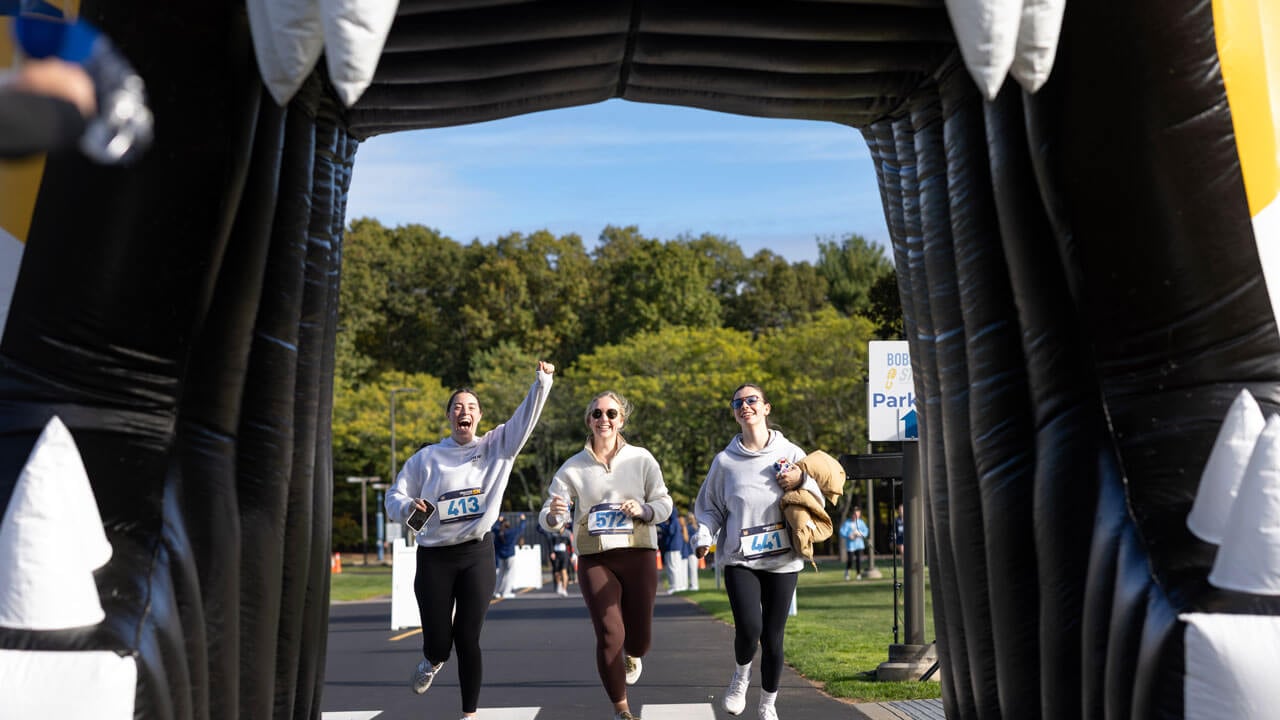 Runners cheer with excitement just before getting to the finish line