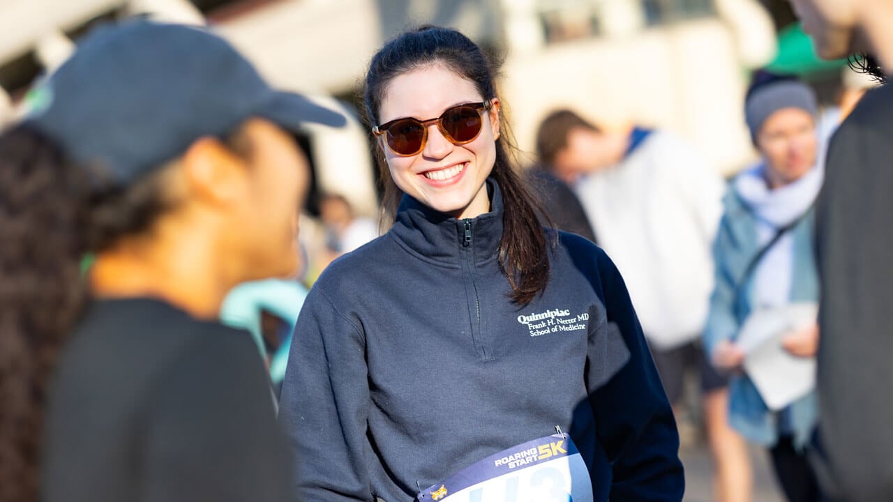 Runner with sunglasses smiling