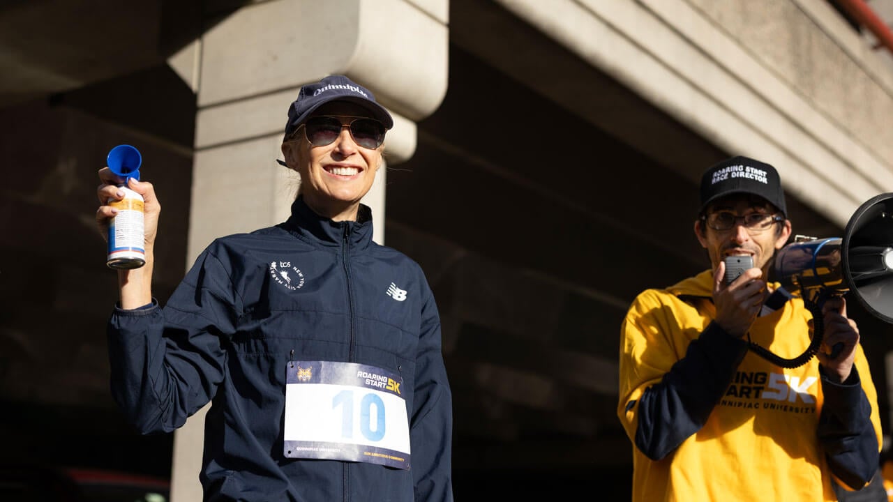 President Hardin holds a airhorn while Jamie Deloma speaks into a megaphone